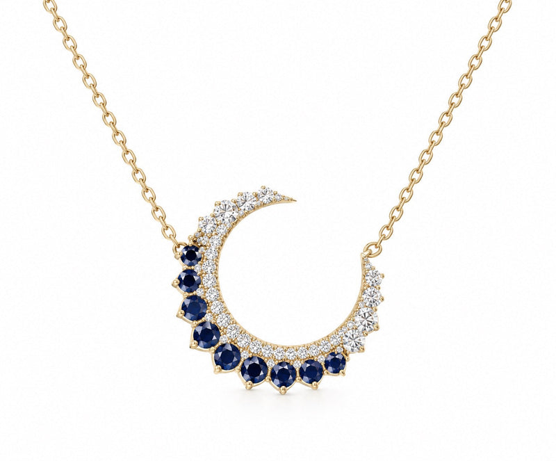 The Karat Concierge 14KT yellow gold crescent moon necklace with brilliant diamonds and rich blue sapphires.