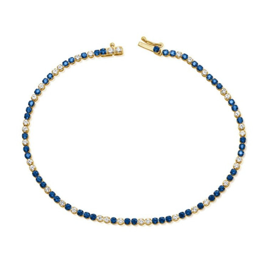 The Karat Concierge tennis bracelet featuring alternating blue sapphires and white diamonds set in 14K yellow gold.