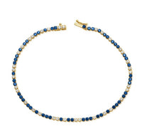 The Karat Concierge tennis bracelet featuring alternating blue sapphires and white diamonds set in 14K yellow gold.