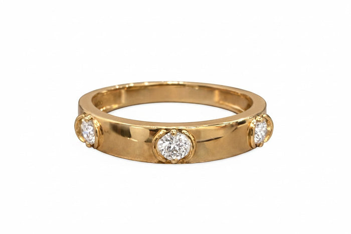 The Karat Concierge 14K yellow gold ring featuring three floating round diamonds in a minimalist bezel setting.