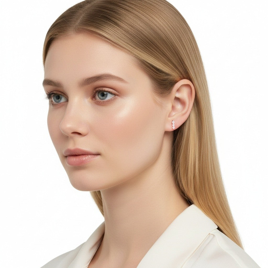 The Karat Concierge trio stud earrings with three round diamonds in a shared prong setting worn by a blonde model