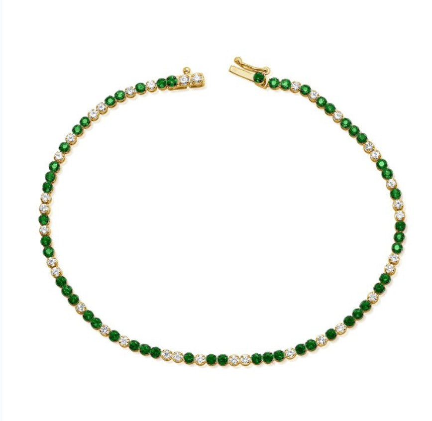 The Karat Concierge tennis bracelet featuring alternating green tsavorite and white diamonds set in 14K yellow gold.