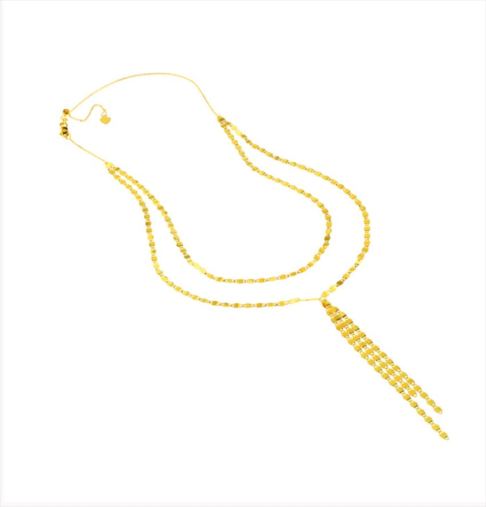 The Karat Concierge Valentino lariat necklace featuring a delicate gold chain with a sliding bolo and tassel drop.