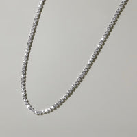 The Karat Concierge 14K white gold tennis necklace featuring 2 CTW crown set diamonds in a delicate 16-inch design.