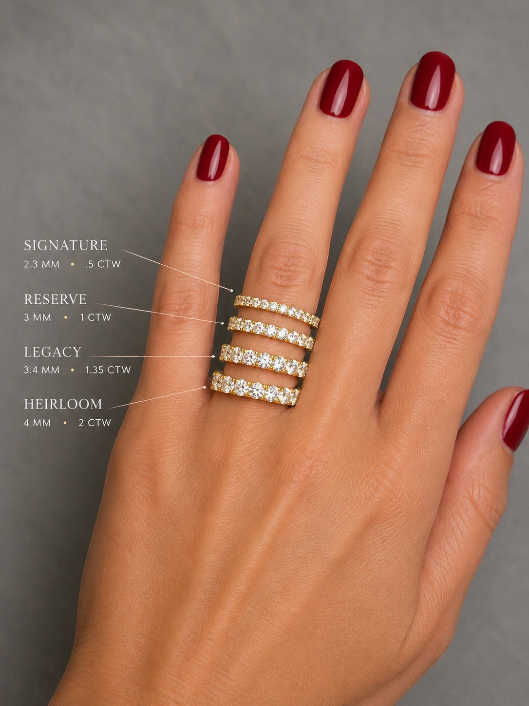 The Karat Concierge yellow gold eternity bands in various diamond sizes worn on a hand with dark red nail polish.
