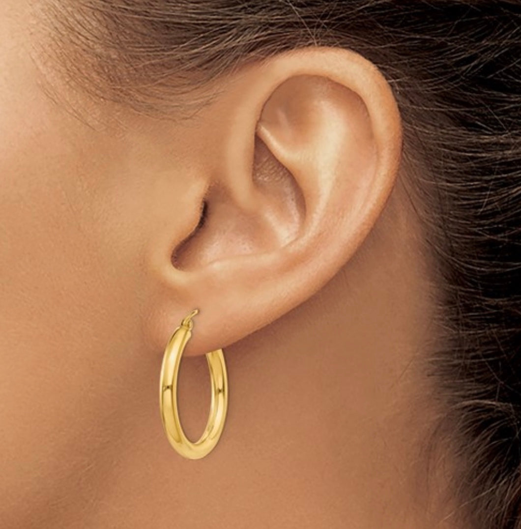 Small 14K gold hoop earrings on display 