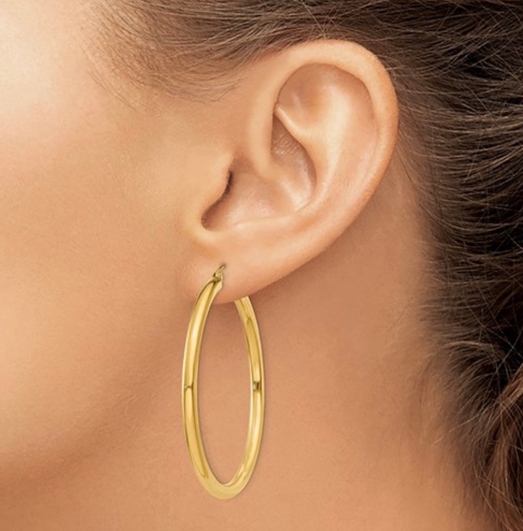 Large 14K gold hoop earrings on display