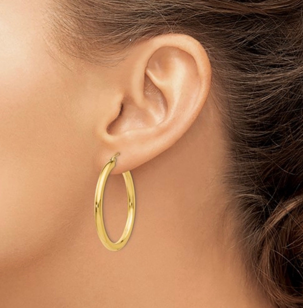 Medium 14K gold hoop earrings on display 